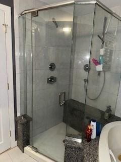 100 E 6th St Unit 2, Dracut, MA 01826 - full bath featuring a stall shower, a garden tub, and tile patterned flooring