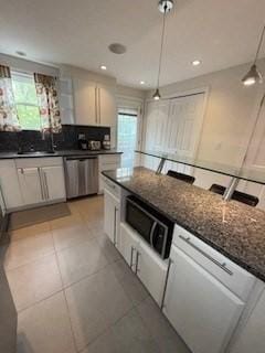 100 E 6th St Unit 2, Dracut, MA 01826 - kitchen featuring stainless steel dishwasher, white cabinetry, pendant lighting, a sink, and dark stone countertops