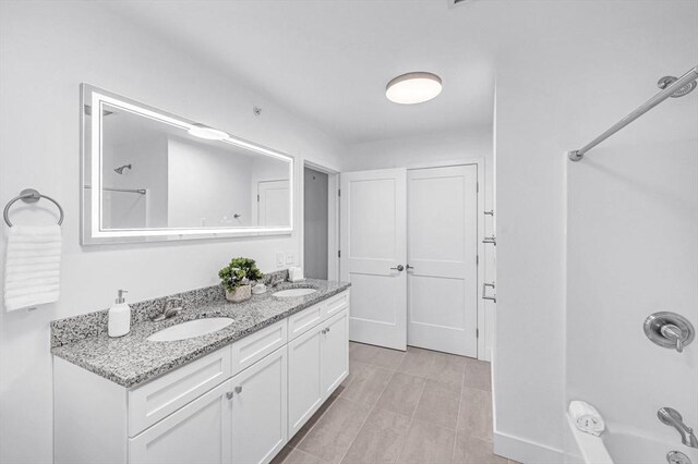 bathroom with vanity and bathtub / shower combination