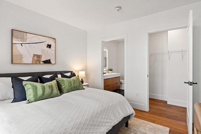 1515 Commonwealth Ave Unit 314, Boston, MA 02135 - bedroom with wood finished floors, a walk in closet, a closet, and ensuite bath