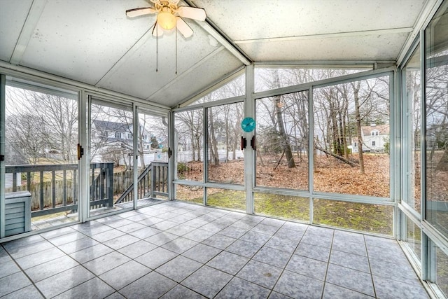 unfurnished sunroom featuring lofted ceiling and ceiling fan