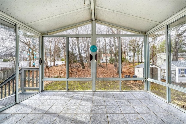 unfurnished sunroom with lofted ceiling