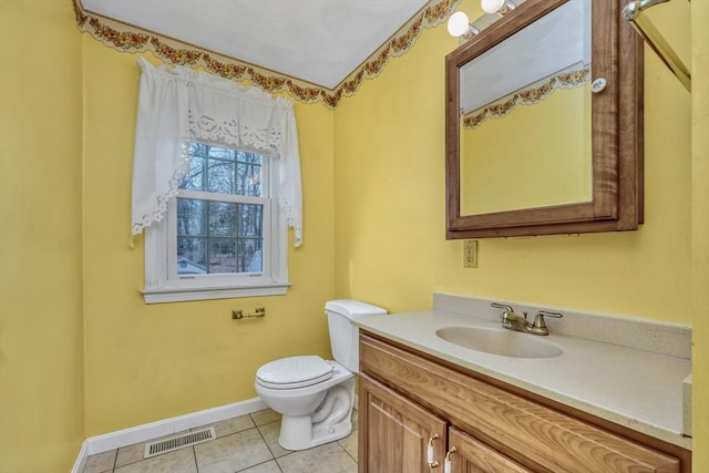 bathroom with tile patterned flooring, visible vents, baseboards, toilet, and vanity