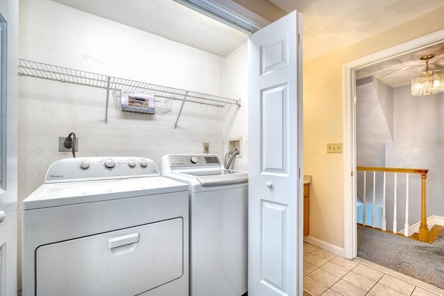 clothes washing area featuring baseboards, light tile patterned floors, laundry area, light carpet, and separate washer and dryer