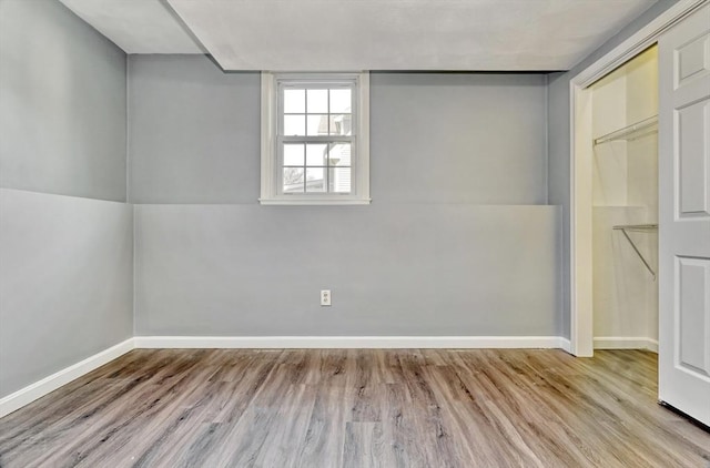 empty room featuring baseboards and wood finished floors