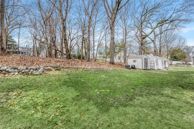 view of yard featuring a shed and an outdoor structure