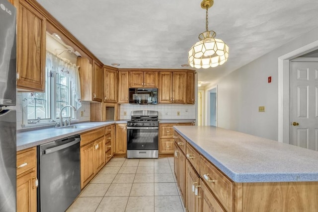 kitchen with backsplash, light countertops, light tile patterned floors, stainless steel appliances, and a sink