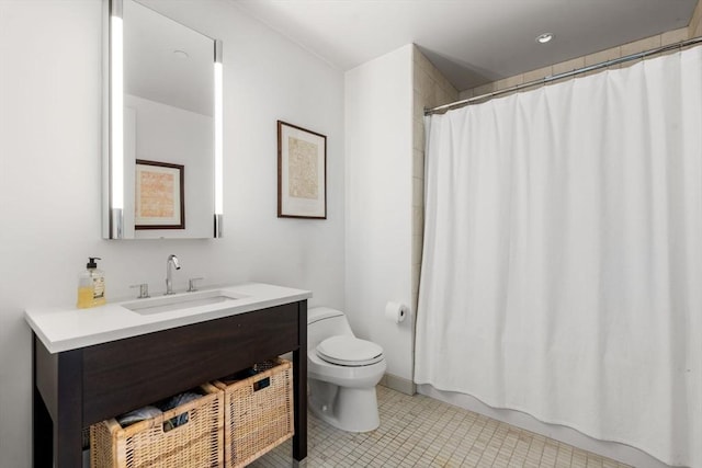 bathroom featuring vanity, tile patterned floors, and toilet