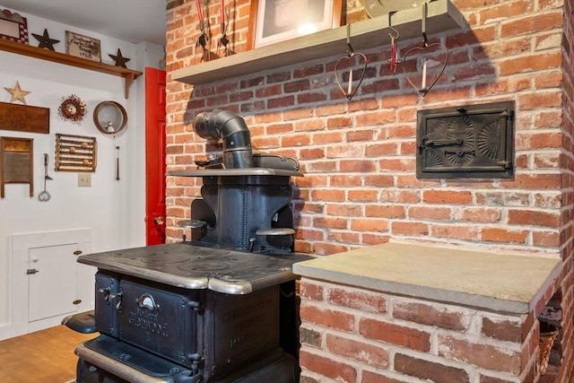 room details featuring hardwood / wood-style floors and a wood stove