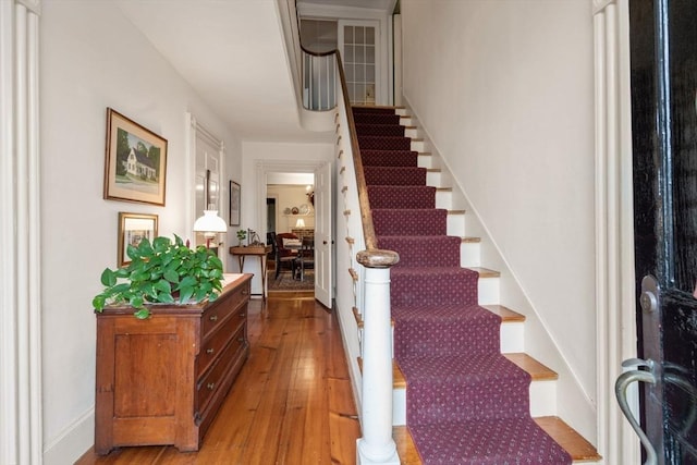 stairs featuring wood-type flooring