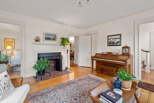 living room featuring hardwood / wood-style flooring and ornamental molding