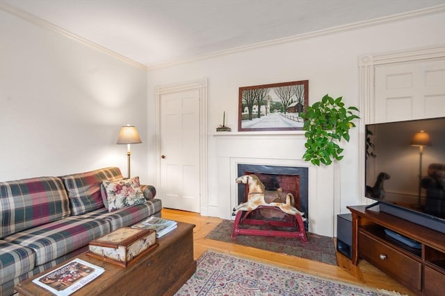 living room featuring light wood-type flooring and ornamental molding