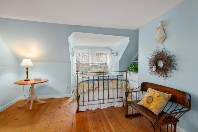 living area featuring hardwood / wood-style flooring and vaulted ceiling