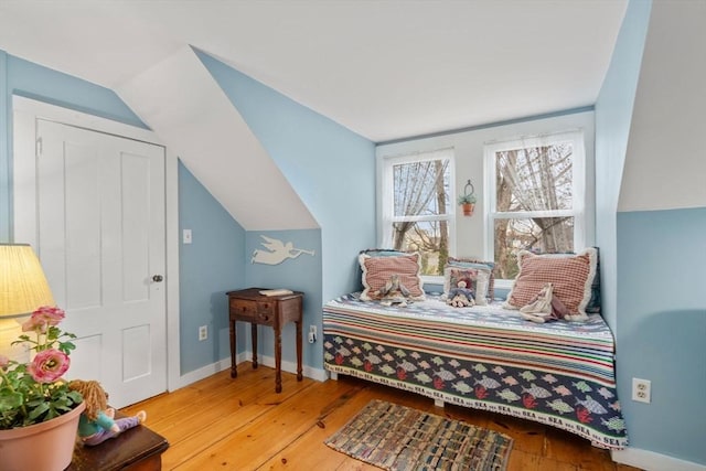 bedroom with light hardwood / wood-style floors and vaulted ceiling