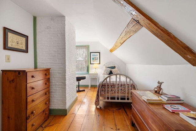 bedroom featuring wood-type flooring and vaulted ceiling