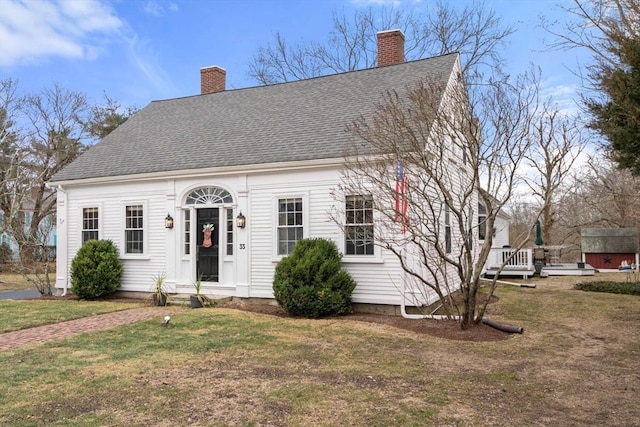 cape cod-style house with a front lawn and a deck