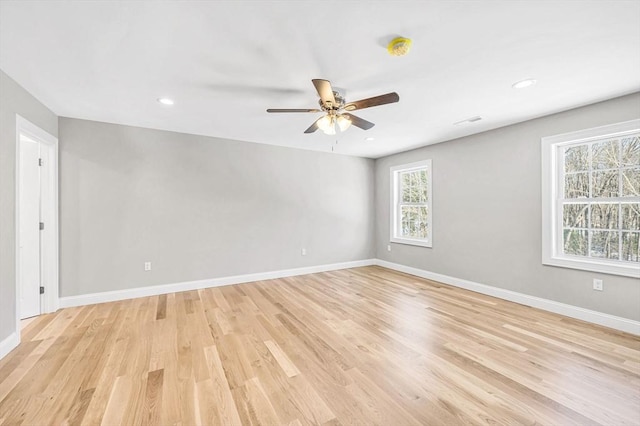 empty room with visible vents, baseboards, ceiling fan, light wood-style floors, and recessed lighting