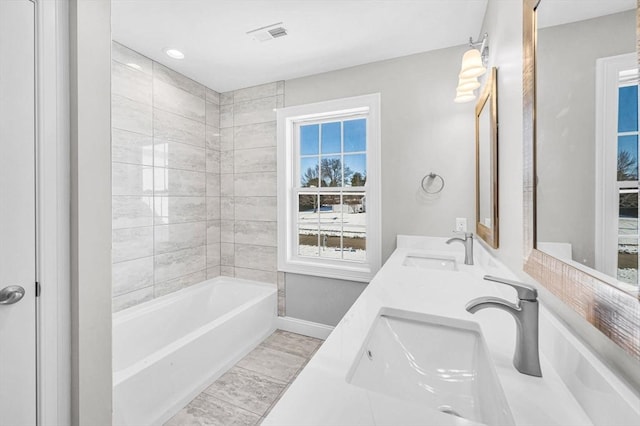 full bathroom featuring a sink, baseboards, and double vanity