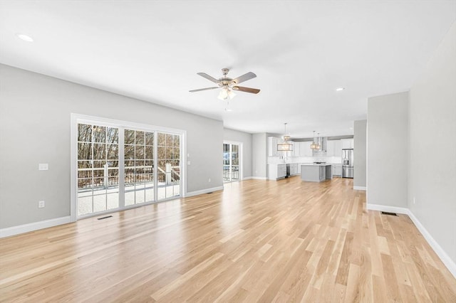 unfurnished living room featuring visible vents, baseboards, ceiling fan, light wood-type flooring, and recessed lighting