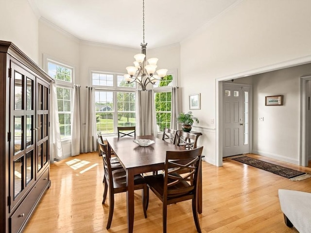 75 Country Way Unit 75, Dartmouth, MA 02748 - dining area featuring crown molding, a chandelier, light wood-style flooring, and a towering ceiling