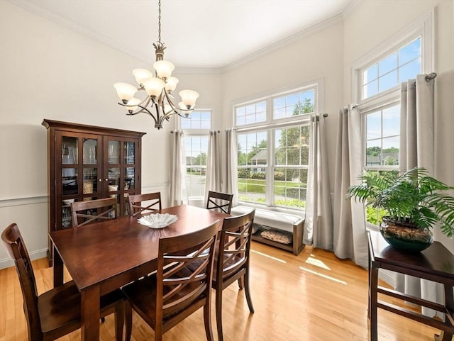 75 Country Way Unit 75, Dartmouth, MA 02748 - dining area with healthy amount of natural light, a chandelier, light wood-type flooring, crown molding, and a towering ceiling