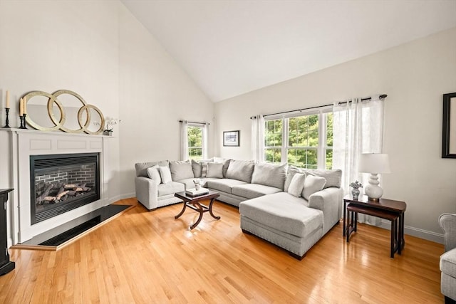 75 Country Way Unit 75, Dartmouth, MA 02748 - living room featuring high vaulted ceiling, light wood-type flooring, and a glass covered fireplace