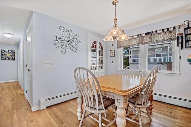 dining room featuring a baseboard radiator and light wood-type flooring