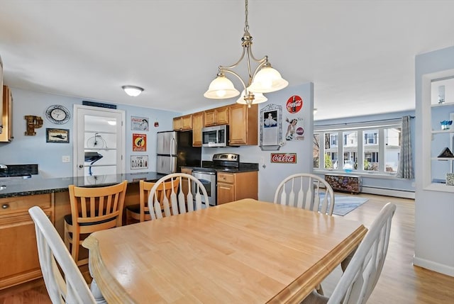 dining room featuring a chandelier, light hardwood / wood-style flooring, and a baseboard radiator