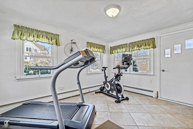 exercise room with light tile patterned floors and a baseboard heating unit