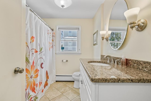 bathroom featuring baseboard heating, a healthy amount of sunlight, tile patterned floors, and vanity