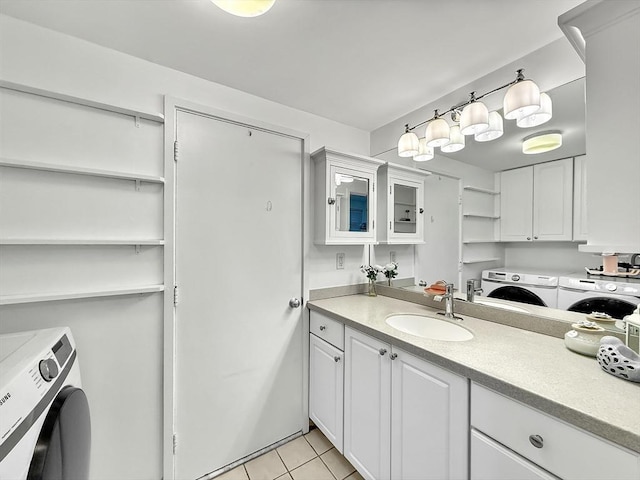 bathroom with tile patterned flooring, vanity, and separate washer and dryer