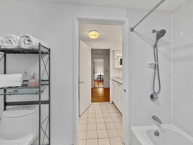 bathroom with tile patterned flooring, toilet, bathing tub / shower combination, and vanity