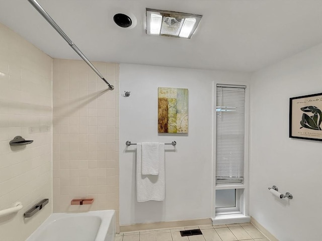 bathroom featuring washtub / shower combination, visible vents, baseboards, and tile patterned floors