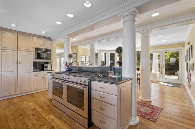 3 Anchorage Ln, Marblehead, MA 01945 - kitchen featuring range with two ovens, ornate columns, crown molding, light wood-type flooring, and dark countertops