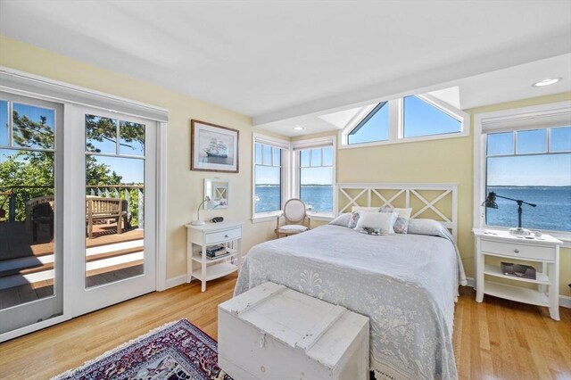 3 Anchorage Ln, Marblehead, MA 01945 - bedroom with wood finished floors, a water view, access to exterior, baseboards, and recessed lighting