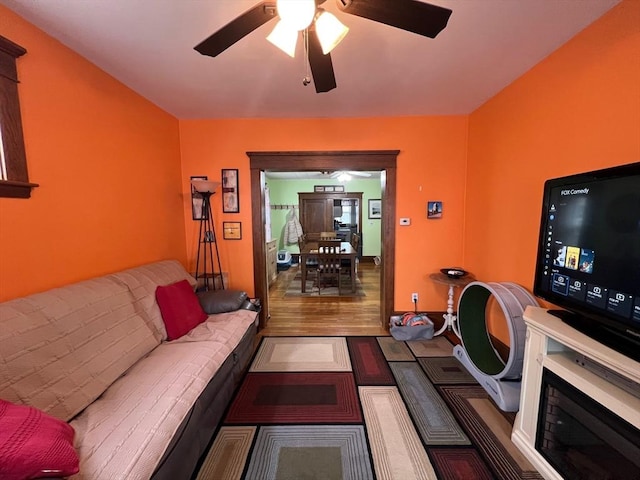 living area featuring ceiling fan and wood finished floors