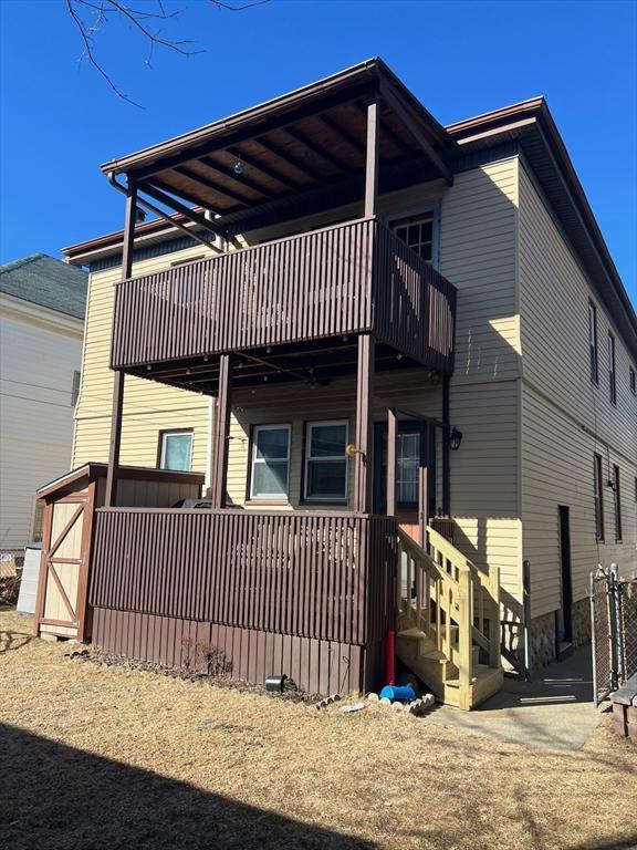 back of property featuring a balcony