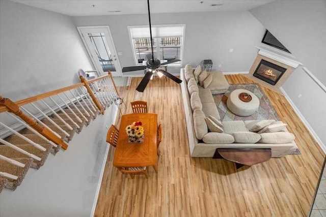 216 Reservoir St Unit 304, Holden, MA 01520 - living area with a glass covered fireplace, baseboards, and wood finished floors