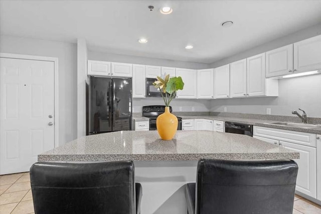216 Reservoir St Unit 304, Holden, MA 01520 - kitchen with a sink, white cabinetry, black appliances, and a center island