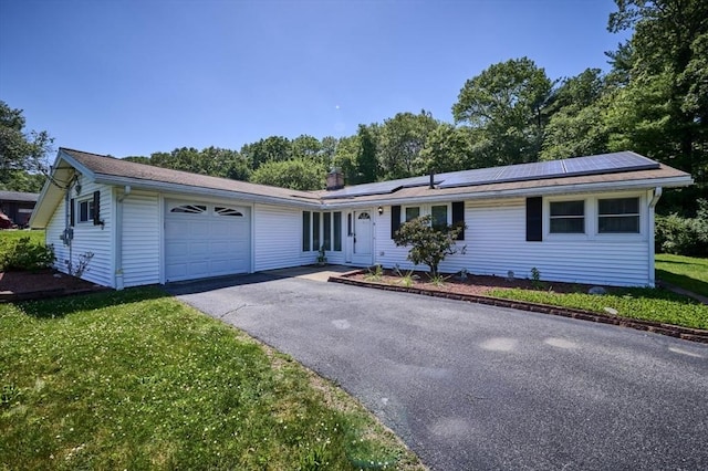 9 Sheffield Rd, Framingham, MA 01701 - ranch-style home with a garage, solar panels, asphalt driveway, and a front yard