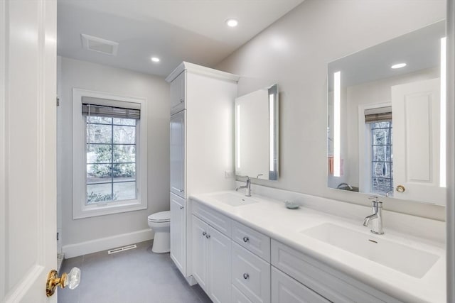 bathroom featuring a sink, visible vents, and toilet