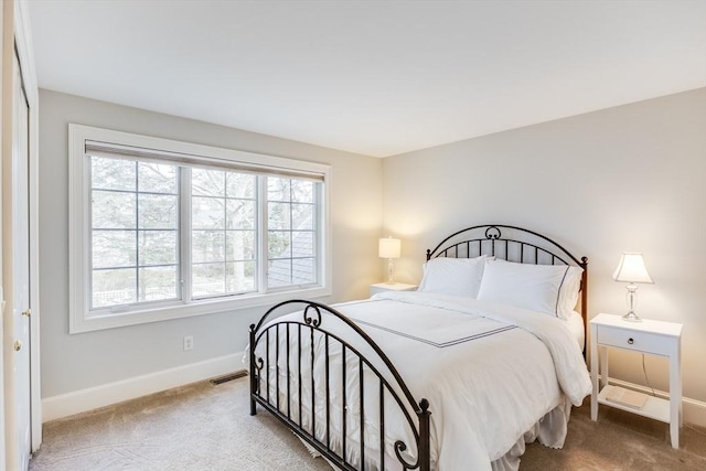 bedroom with visible vents, baseboards, and carpet