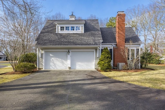 view of front of home with a front lawn, cooling unit, a chimney, and a shingled roof