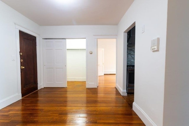 unfurnished bedroom with dark hardwood / wood-style flooring and a closet