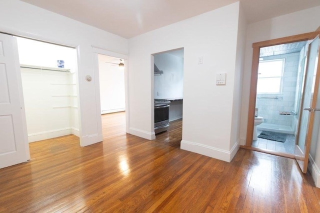 interior space with hardwood / wood-style flooring and a baseboard radiator