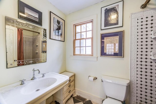 50 Higgins Ln, Wellfleet, MA 02667 - bathroom with toilet, a shower with curtain, a sink, and baseboards