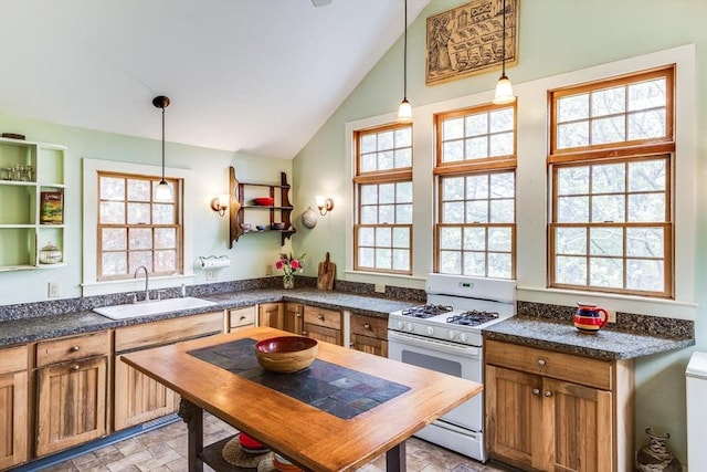 50 Higgins Ln, Wellfleet, MA 02667 - kitchen with white range with gas cooktop, a sink, plenty of natural light, stone finish flooring, and vaulted ceiling