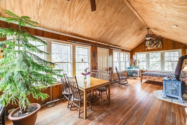 50 Higgins Ln, Wellfleet, MA 02667 - dining space with ceiling fan, hardwood / wood-style flooring, a wood stove, wood walls, and wood ceiling