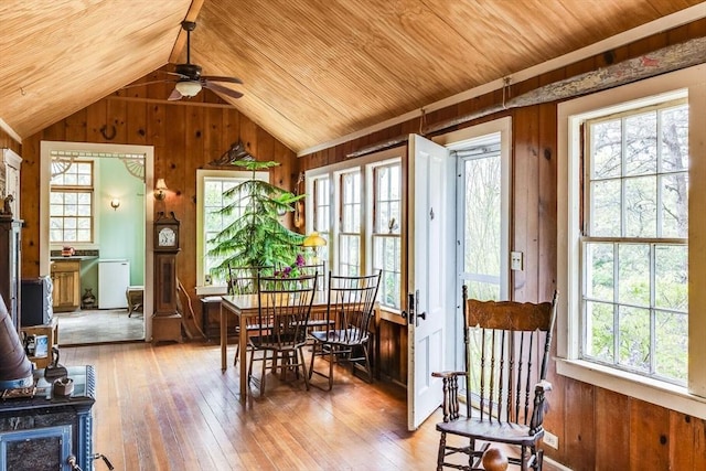 50 Higgins Ln, Wellfleet, MA 02667 - dining space with wooden walls, wooden ceiling, hardwood / wood-style flooring, a wood stove, and lofted ceiling