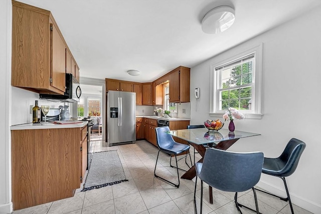 209 Brookside Rd, Needham, MA 02492 - kitchen featuring stainless steel fridge with ice dispenser, brown cabinetry, light countertops, and dishwasher